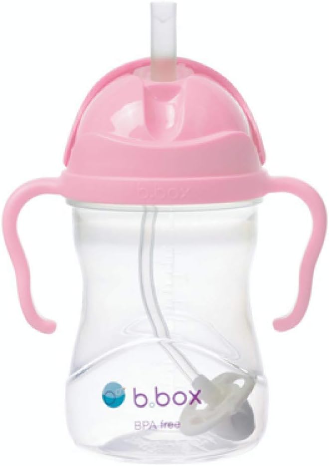 A pink sippy cup with a strawDescription automatically generated