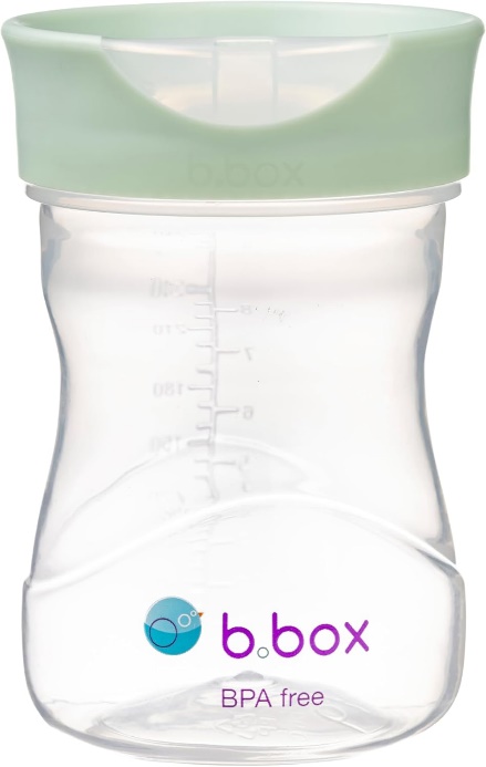 A baby bottle with a green lidDescription automatically generated